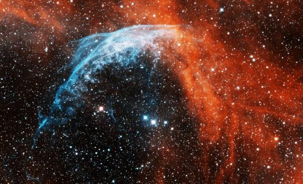 Wolf-Rayet Star: starry sky with orange and blue nebula around a star.