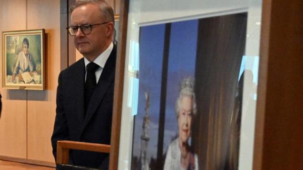 Prime Minister Anthony Albanese stands near an image of Queen Elizabeth II following her death, after signing the co<em></em>ndolence book at Parliament House in Canberra, Australia, September 9, 2022. AAP Image/Mick Tsikas via REUTERS ATTENTION EDITORS - THIS IMAGE WAS PROVIDED BY A THIRD PARTY.